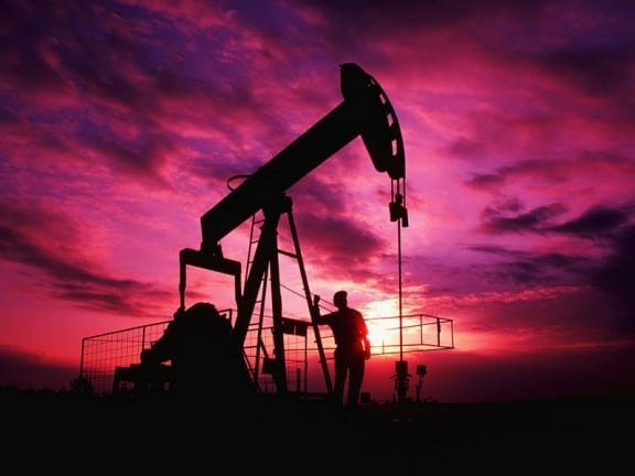 Alabama, USA. Worker Checking Oil Pump