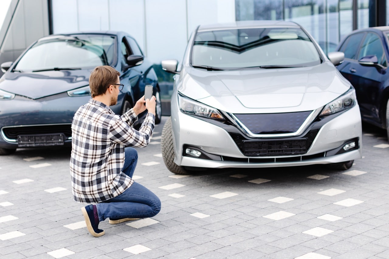 Un particulier fait des photos de sa voiture pour la mettre en vente